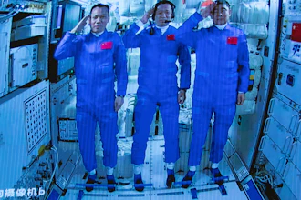 Chinese astronauts salute after successfully entering the Tianhe space station module as seen on a screen at the Beijing Aerospace Control Center, June 17, 2021.