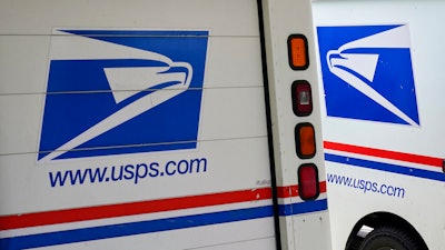 Mail delivery vehicles parked outside a post office in Boys Town, Neb., Aug. 18, 2020.