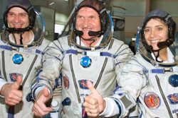 French astronaut Claudie Haignere, right, and her Russian crewmates Viktor Afanasyev, center, and Konstantin Kozeyev train inside the mock-up of a Soyuz TM spacecraft in Star City, July 5, 2001.