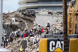 Search and rescue personnel search for survivors through the rubble at the Champlain Towers South Condo, Surfside, Fla., June 25, 2021.
