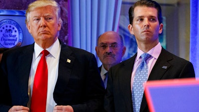 Then-President-elect Donald Trump, CFO Allen Weisselberg, center, and Donald Trump Jr., right, at a news conference in the lobby of Trump Tower, New York, Jan. 11, 2017.