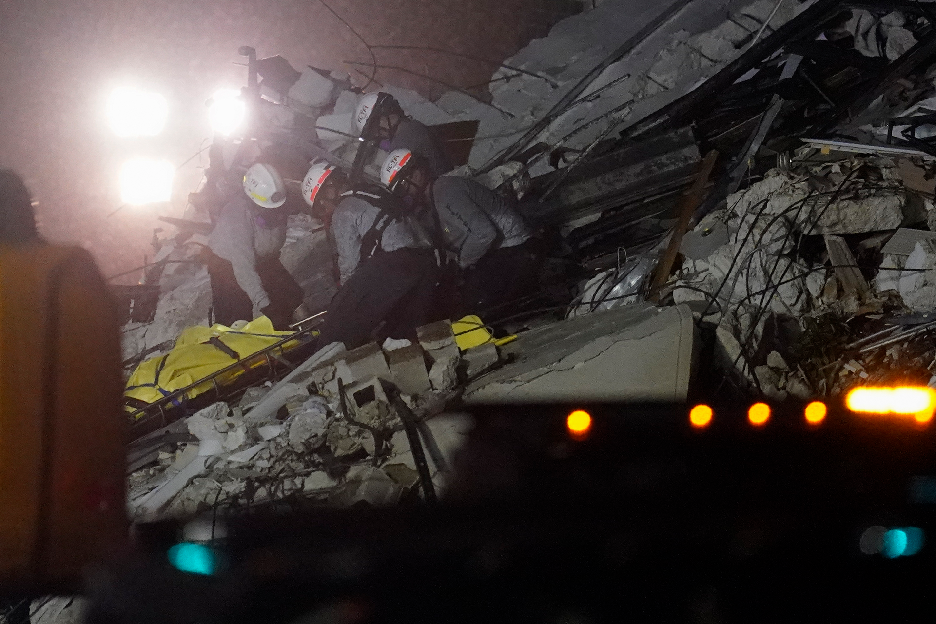 Rescue workers remove a body from the rubble where a wing of a 12-story beachfront condo building collapsed, Thursday, June 24, 2021, in the Surfside area of Miami.