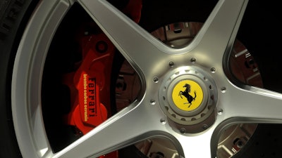 In this Wednesday, May 8, 2013 file photo a Ferrari logo is displayed on a wheel in the department Ferrari factory in Maranello, Italy. Luxury sports carmaker Ferrari has tapped Benedetto Vigna, an Italian executive at Europe’s largest semiconductor chipmaker, as its new CEO, the company announced Wednesday, June 9, 2021.