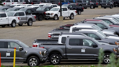 Ford pickup trucks built lacking computer chips are shown in parking lot storage in Dearborn, Mich., Tuesday, May 4, 2021. Automakers are cutting production as they grapple with a global shortage of computer chips, and that's making dealers nervous.