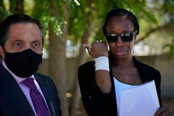 Lawyer Javier Villalba, left and John McAfee's wife Janice speak briefly with journalists on leaving the Brians 2 penitentiary center in Sant Esteve Sesrovires, near Barcelona, northeast Spain, Friday, June 25, 2021.