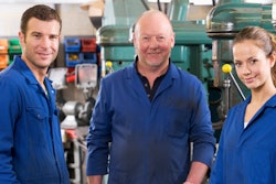 Three Machinists In Workspace By Machine Talking 000025283641 Medium