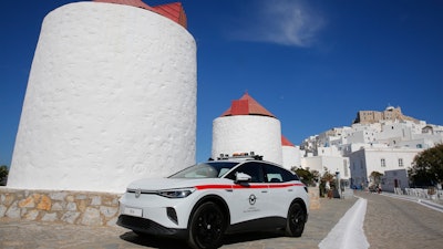 A Volkswagen ID.4 electric car of the Civil Aviation is parked on the Aegean Sea island of Astypalea, Greece during the official launch of a project to introduce and test electric vehicles and sustainable energy systems on Wednesday, June 2, 2021. The government has partnered with the German carmaker on the island project aimed a switching to electric vehicle use over the next five years.