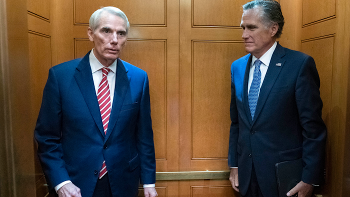 Sen. Rob Portman, R-Ohio, left, and Sen. Mitt Romney, R-Utah, leave in the elevator after a closed door talks about infrastructure on Capitol Hill, July 15, 2021.