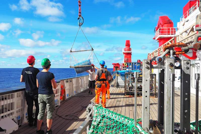 Catching a big blue barrel floating on the ocean surface in the Great Pacific Garbage Patch from the German research vessel SONNE during expedition SO268/3 crossing the North Pacific Ocean from Vancouver to Singapore in summer, 2019.