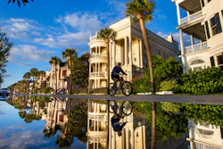 A bicyclist makes his way down East Battery as a king tide rolls into the historic Battery, Charleston, S.C., Nov. 15, 2020.