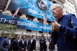 In this Monday, Oct. 28, 2019 file photo, Richard Branson, right, founder of Virgin Galactic, and company executives gather for photos outside the New York Stock Exchange before his company's IPO. Branson announced Thursday, July 1, 2021 he plans to fly into space this month on the next test flight of his Virgin Galactic rocket ship. The launch window will open July 11.