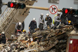 Search and rescue personnel work atop the rubble at the Champlain Towers South condo building, Surfside, Fla., June 30, 2021.