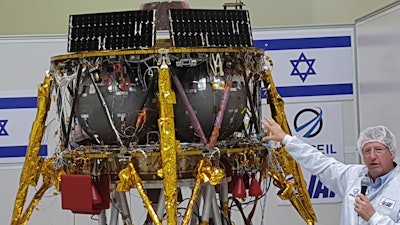 Opher Doron, general manager of Israel Aerospace Industries' space division, speaks beside the SpaceIL lunar module, July 10, 2018, near Tel Aviv.