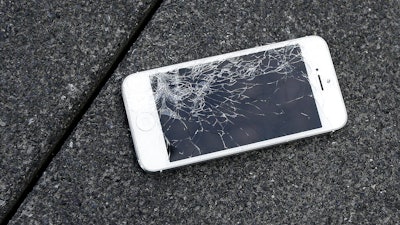An iPhone with a cracked screen after a drop test in San Francisco, Aug. 26, 2015.