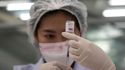 A health worker prepares a shot of the AstraZeneca COVID-19 vaccine at the Central Vaccination Center in Bangkok, July 22, 2021.