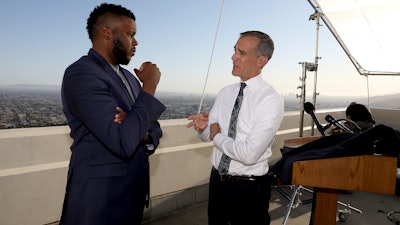 Los Angeles Mayor Eric Garcetti, right, talks with Michael Tubbs, founder of Mayors for a Guaranteed Income, after his State of the City address from the Griffith Observatory, Los Angeles, April 19, 2021.