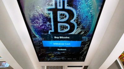 Bitcoin logo on a cryptocurrency ATM at the Smoker's Choice store, Salem, N.H., Feb. 9, 2021.