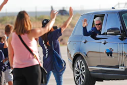Virgin Galactic founder Richard Branson waves to school children while heading to board the rocket plane that will fly him to space from Spaceport America near Truth or Consequences, New Mexico, Sunday, July 11, 2021.