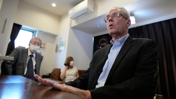Former Nissan Motor Co. executive Greg Kelly, right, accompanied by his wife Dee Kelly and his lawyer Yoichi Kitamura, during an interview with the Associated Press in Tokyo, Aug. 18, 2021.