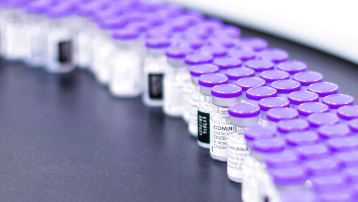 Vials of the Pfizer-BioNTech COVID-19 vaccine are prepared for packaging at the company's facility in Puurs, Belgium, March 2021.