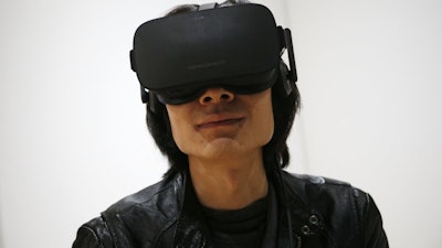 Peijun Guo wears the Oculus Rift VR headset at CES International in Las Vegas, Jan. 6, 2016.