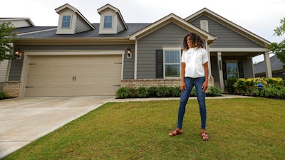 Crystal Marie McDaniels poses in front of her home in Charlotte, N.C., July 9, 2021.