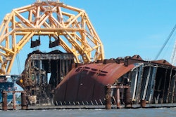 A crane pulls the engine room section away from the remains of the capsized cargo ship Golden Ray offshore of St. Simons Island, Ga., April 26, 2021.