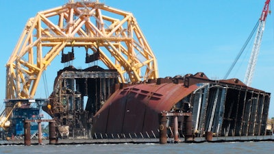 A crane pulls the engine room section away from the remains of the capsized cargo ship Golden Ray offshore of St. Simons Island, Ga., April 26, 2021.