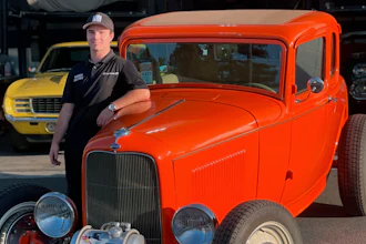 Cole Kleis standing next to a 1932 Ford Coup in front of a garage in Napa, Calif., August 2020.