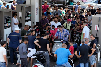 Motorcycle drivers wait to get fuel at a gas station in a southern suburb of Beirut, June 27, 2021.