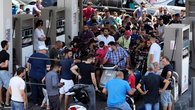 Motorcycle drivers wait to get fuel at a gas station in a southern suburb of Beirut, June 27, 2021.