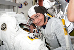 Astronaut and Expedition 65 Flight Engineer Mark Vande Hei inspects a spacesuit in preparation for a spacewalk at the International Space Station, Aug. 17, 2021.