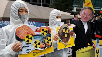 Activists protest the Japanese government's decision to release treated radioactive water, near the Japanese Embassy in Seoul, April 13, 2021.