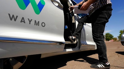 A Waymo minivan arrives to pick up passengers, Mesa, Ariz., April 7, 2021.
