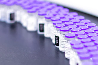 Vials of the Pfizer-BioNTech COVID-19 vaccine are prepared for packaging at the company's facility in Puurs, Belgium, March 2021.