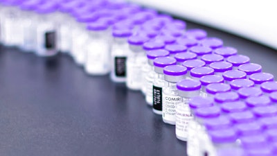 Vials of the Pfizer-BioNTech COVID-19 vaccine are prepared for packaging at the company's facility in Puurs, Belgium, March 2021.