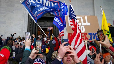 Insurrections loyal to President Trump riot outside the Capitol in Washington, Jan. 6, 2021.