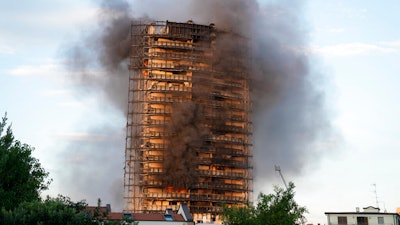 Smoke billows from a building in Milan, Italy, Aug. 29, 2021.