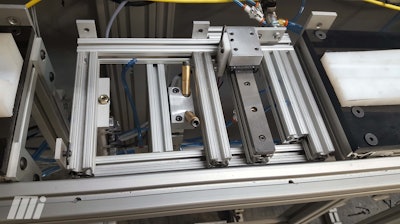 A protective film application machine used in the manufacturing sector. The cutter head section of the machine uses the square rail and bearing to index the cutter.
