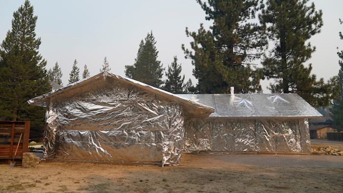 Martin Diky's home completely wrapped in fire-resistant material to protect against the approaching Caldor Fire in Meyers, Calif., Sept. 1, 2021.
