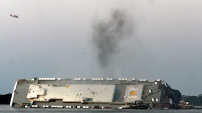 Smoke rises from a cargo ship capsized in the St. Simons Island, Georgia, sound, Sept. 8, 2019.