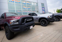 Unsold 2021 Ram pickup trucks parked on the storage lot outside a Ram dealership, Littleton, Colo., Aug. 29, 2021.