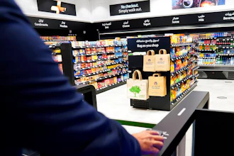 A man uses a QR code on a mobile phone to enter Carrefour's new cashier-less grocery store in Mall of the Emirates in Dubai, Sept. 6, 2021.