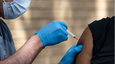 National Guard Spc. Noah Vulpi, left, administers the Johnson & Johnson COVID-19 vaccine to Ira Young Jr. during a vaccination clinic held by the National Guard in Odessa, Texas, May 27, 2021.