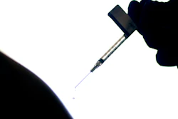 A droplet falls from a syringe after a person was injected with the Pfizer COVID-19 vaccine at a hospital in Providence, R.I., Dec. 15, 2020.