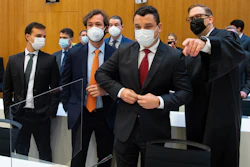 Paulo Richardo Rocha Pinto, husband of a victim, lawyer Pedro Martins, Gustavo Barroso Camara, brother of a victim, and lawyer Jan Erik Spangenberg, from left, arrive at the Munich Regional Court , Sept. 28, 2021.