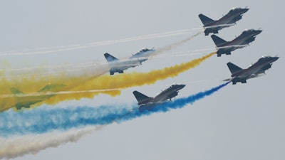 Members of the 'August 1st' Aerobatic Team perform during the 13th China International Aviation and Aerospace Exhibition, Zhuhai, Sept. 29, 2021.