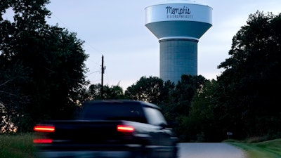 A truck drives down a rural road near a water tower marking the location of the Memphis Regional Megasite on Sept. 24, 2021, in Stanton, Tenn. Ford Motor Co. and SK Innovation of South Korea plan to build three new electric-vehicle battery factories and an auto assembly plant by 2025 in Tennessee and Kentucky. The industrial site in Stanton will be the location for a factory to produce electric F-Series pickups and a battery factory.