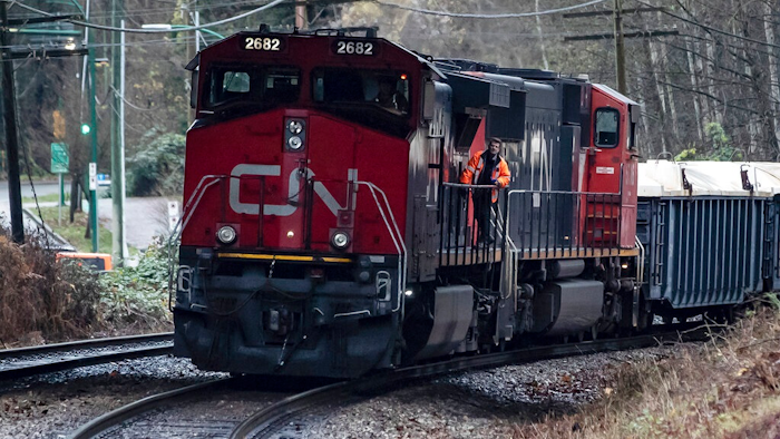 In this Nov. 27, 2020 file photo, a Canadian National rail worker stands on an idle locomotive as protesters opposed to the Trans Mountain pipeline expansion block rail lines in Burnaby, British Columbia. After walking away from its effort to buy Kansas City Southern railroad earlier this month, Canadian National continues to face investor pressure to make changes in its operation. The London-based investment firm TCI Fund — which owns about 5% of CN’s stock — is pressing for CN to overhaul its board, get a new CEO and improve its own operations.