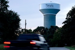 A truck drives down a rural road near a water tower marking the location of the Memphis Regional Megasite, Sept. 24, 2021, Stanton, Tenn.